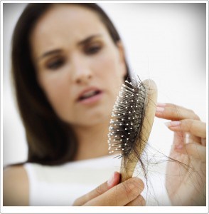 woman distraught at hair loss